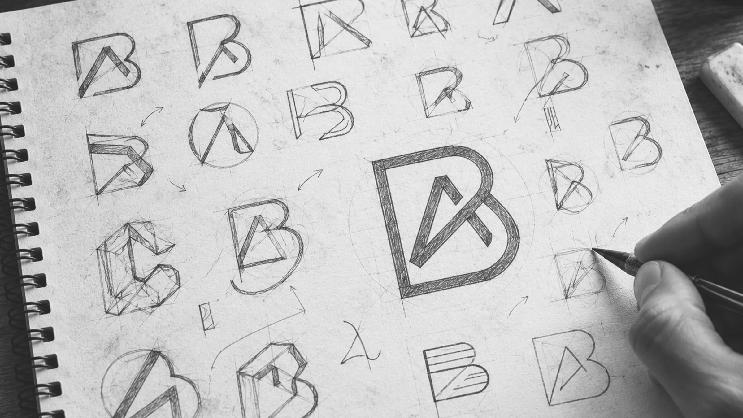 Pencil sketches exploring the Baylis Associates B and A monogram